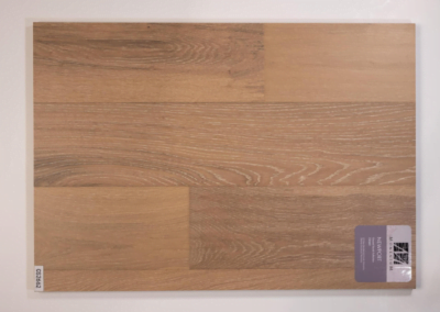 A picture of a wooden floor with a label on it, showcasing the exquisite craftsmanship of a Custom Home Builder.