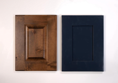 Two wooden cabinet doors on a white wall in a custom home.