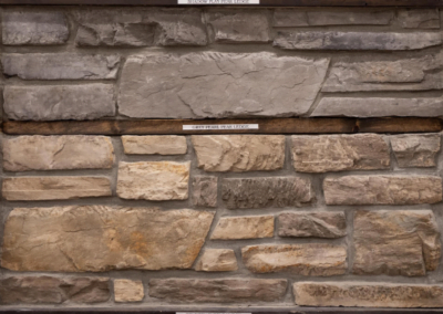A picture of a stone wall in a frame by Riding Homes, a Custom Home Builder in Southern Utah Valley.