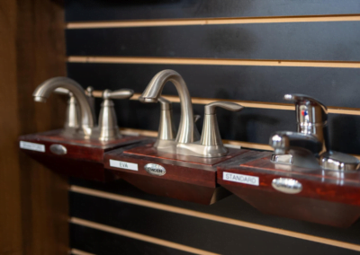 A row of faucets on a wall in a custom home built by Riding Homes in Southern Utah Valley.
