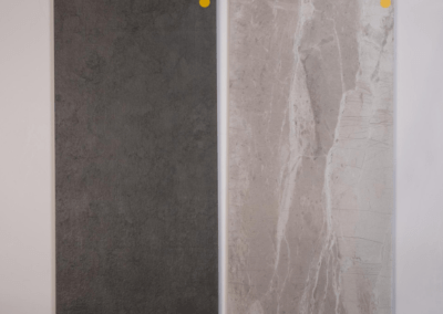 A yellow arrow design on a white and grey marble tile designed by Riding Homes, a custom home builder in Southern Utah Valley.
